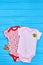 Baby clothes and accessories, wooden background.