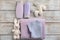 Baby clothes, bath cosmetics, towel and toys on wooden background