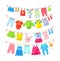 Baby clothes hanging on clothesline. Drying children`s clothes and accessories after washing on rope. Shorts, socks, romper,