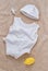 Baby clothes and pacifier on soft towel