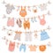 Baby clothes on rope. Newborn children apparel, socks, dress and toys hanging on clothesline. Kids laundry drying on