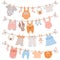 Baby clothes on rope. Newborn children apparel, socks, dress and toys hanging on clothesline. Kids laundry drying on clothespin