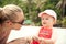 Baby communicate with mother on tropical beach during summer holidays