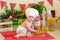 A baby in a cook`s hat sits in a beautiful photo zone with flour and vegetables, a baby cook, a child with flour and bread