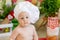 A baby in a cook`s hat sits in a beautiful photo zone with flour and vegetables, a baby cook, a child with flour and bread