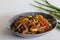 Baby corn chilly. An Indo Chinese dish with crisp fried baby corn in a spicy sauce with sauteed onions and bell peppers