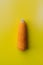 Baby corn vertical position on yellow background