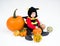 Baby in costume with pumpkins on white background