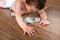 Baby crawling on the floor in search of money, and finds dollar bills lying on the floor