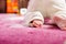 Baby crawling on pink carpet