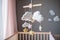 Baby crib mobile with stars, clouds and moon. Kids handmade toys above the newborn crib. First baby eco-friendly toys made from