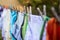 Baby cute clothes hanging on the clothesline outdoor. Child laundry hanging on line in garden