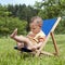 Baby on deckchair in garden