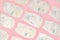 Baby diapers collection on pink color background. Newborn diapers flat lay, top view. Many white baby diapers