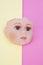 Baby Doll Head, Arms, Face Parts on Yellow and Pink Background