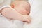 Baby in dreamland. A baby girl fast asleep in between her white pillows.