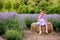 Baby in a dress plays hay in a lavender field