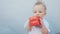 baby drooling bubbles on the lips a toddler play with a cube at home. little boy son fun portrait close-up. little baby