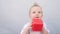 baby drooling bubbles on the lips a toddler play with a cube at home. little boy son portrait close-up. little baby