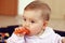 Baby eating carrot