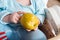 Baby eating fruit. Little boy biting apple sitting in white high chair in sunny kitchen with window and sink. Healthy nutrition