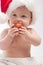 Baby eating red Xmas ball