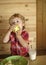 Baby eats an apple in a village hut. Breakfast, morning, family.