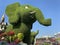 Baby elephant covered with green plants in Miracle garden, Dubai