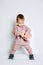 Baby fashion. Unisex clothes for babies. Cute baby in cotton set suit on light background.