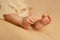 Baby feet on a beige background, tiny toes in a selective focus