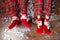 Baby feet in christmas socks and pajama pants on background of shiny confetti. Christmas and new year holiday concept