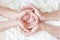 Baby feet in the hands of parents, Newborn baby feet in white cloth wrapped in heart, baby life