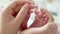 Baby feet in mother hands. Tiny Newborn Baby`s feet on female Heart Shaped hands closeup. Mom and her Child. Happy