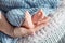 Baby feet in mother hands. Tiny newborn baby`s feet on female shaped hands closeup. Mom and her child. Beautiful conceptual image