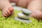 Baby feet next to stack of zen stones