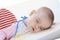 Baby fell asleep while feeding on a white background isolate