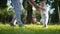 baby first steps in the park. happy family in the park on vacation. dad teaches baby son to take the first steps on the