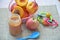 Baby food, baby fruit mashed in a glass jar, peach, beautiful peaches in a basket, children`s toy. apple