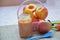 Baby food, baby fruit mashed in a glass jar, peach, beautiful peaches in a basket, children`s toy. apple