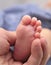 Baby foot in father hand, macro shot