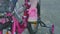 Baby foot pedal on pink bike on the sidewalk in city