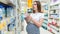 Baby formula pregnant woman shopping. Young pregnant woman buying infant baby formula milk on supermarket background