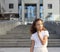 Baby girl on a background of a modern building