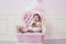 Baby girl beautiful and happy pink interior with vintage chair a