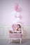 Baby girl beautiful and happy pink interior with vintage chair a