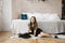 Baby girl in black dress sitting by the bed and typewriter, writing letters