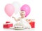 Baby girl with cake, balloons and gifts
