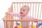 Baby girl at children`s playpen.