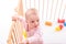 Baby girl at children`s playpen.