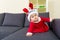 Baby girl with christmas dressing and crawling on sofa